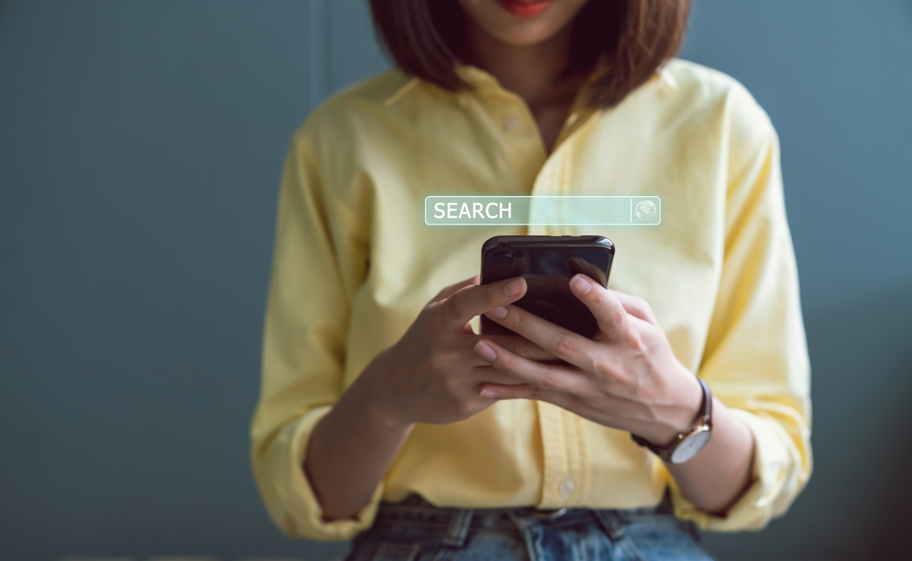 woman using smartphone to search on Google - SEO in Nashville matters